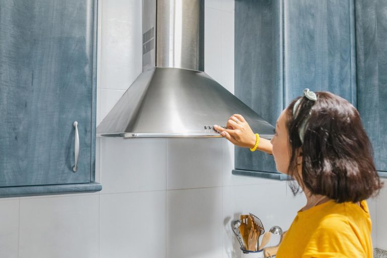 woman-turning-on-kitchen-hood